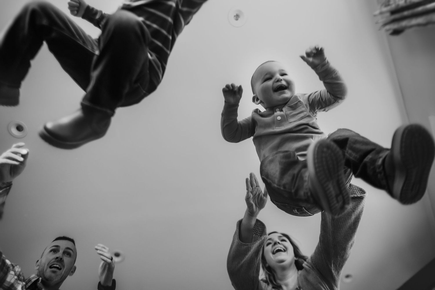 Black and white photo series showing people jumping and dancing energetically at what appears to be a concert or party.