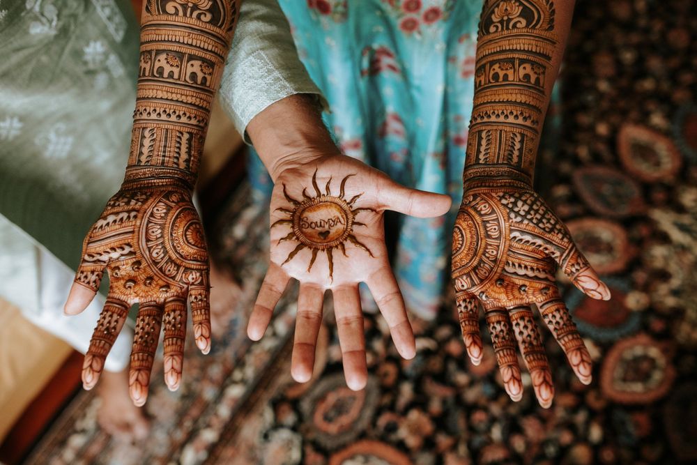 Series of detailed henna mehndi designs on hands showing traditional bridal patterns and motifs.