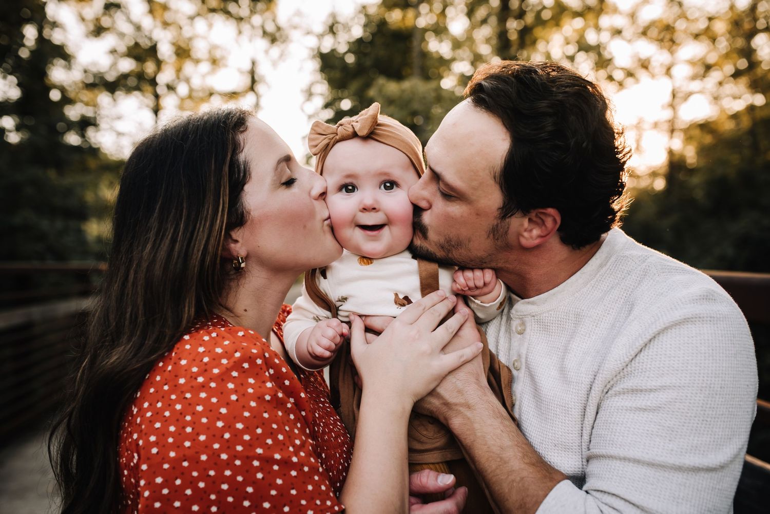 A family shares tender moments together outdoors during golden hour sunset in a series of intimate portraits. Family photographer in Middle