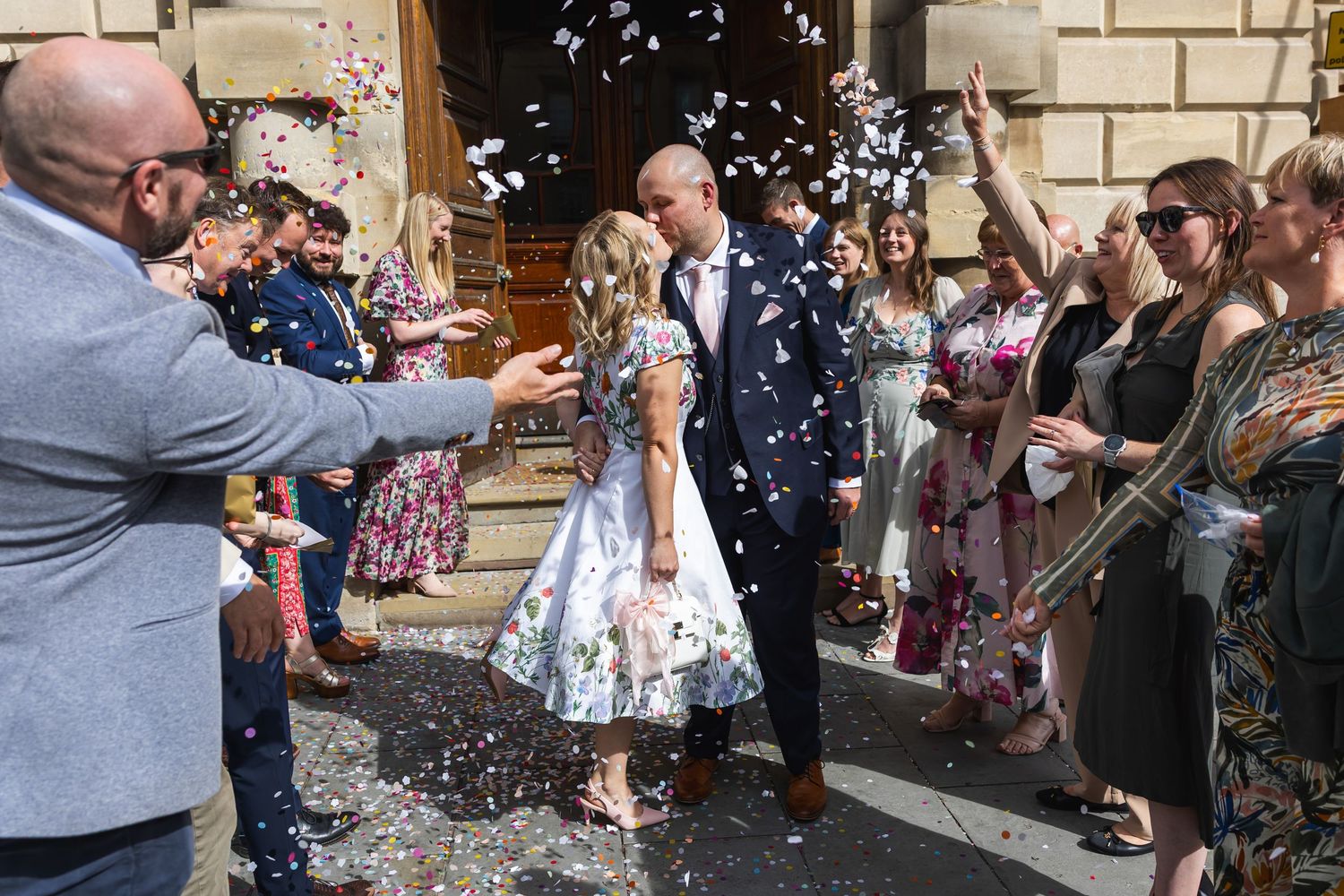 Guildhall Wedding Photography with Bride & Groom kissing with Confetti outside the Bath Guildhall after their wedding ceremony