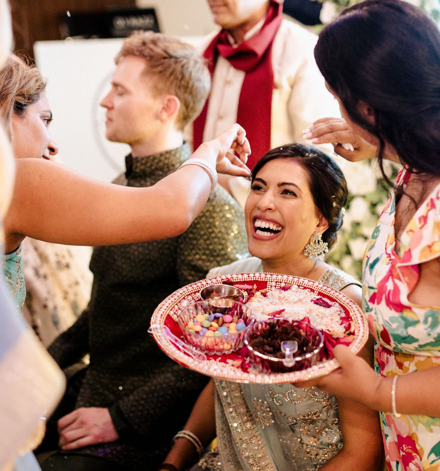 A curled updo and pinky makeup tones for this vibrant traditional Indian wedding