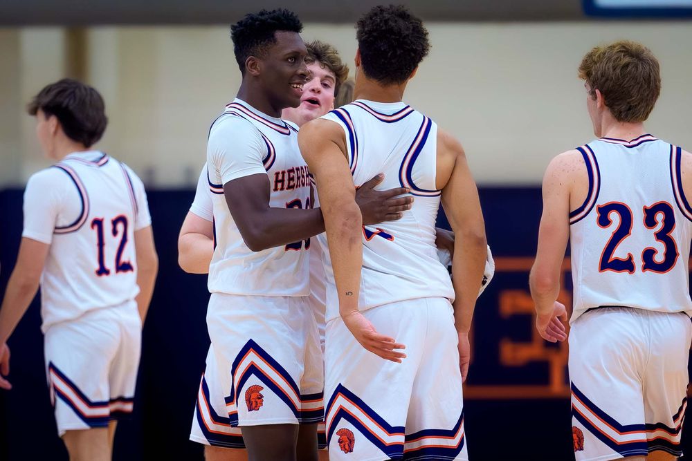 Cam Sweeney and Hershey teammates share a moment on the court after his 1,000th point milestone.