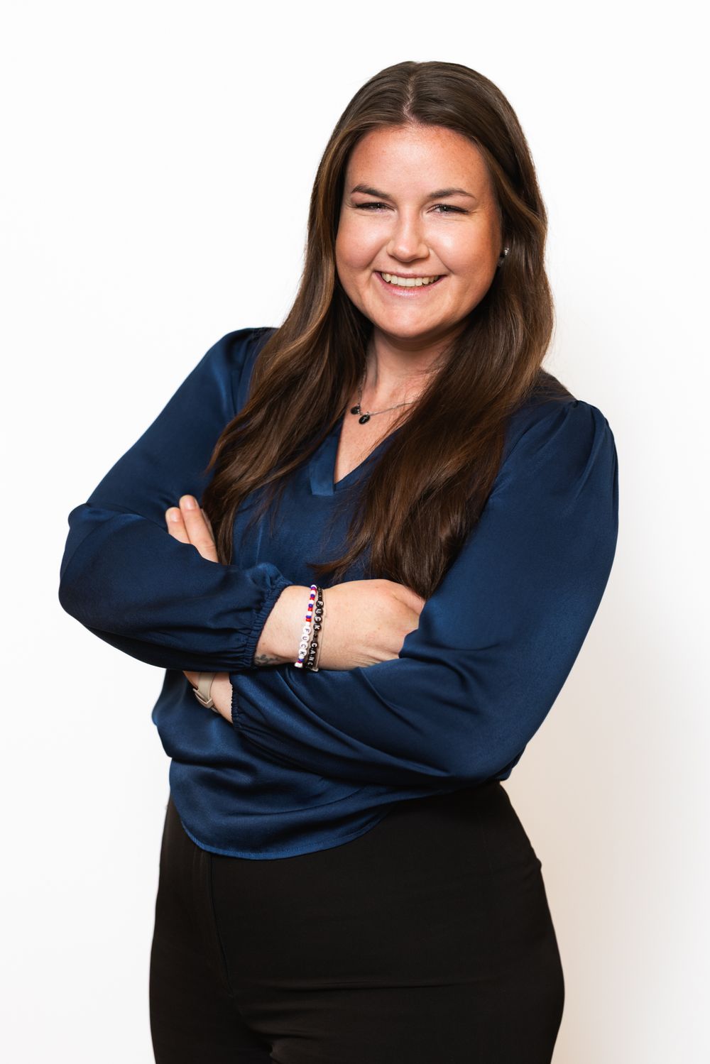 Business headshots of person in navy blazer showing friendly expressions against white backdrop.