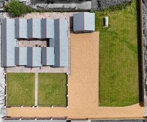 Aerial view of modern residential buildings with solar panels and well-maintained lawns.