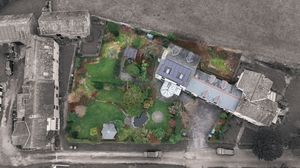 Satellite view of urban buildings and green spaces from above.