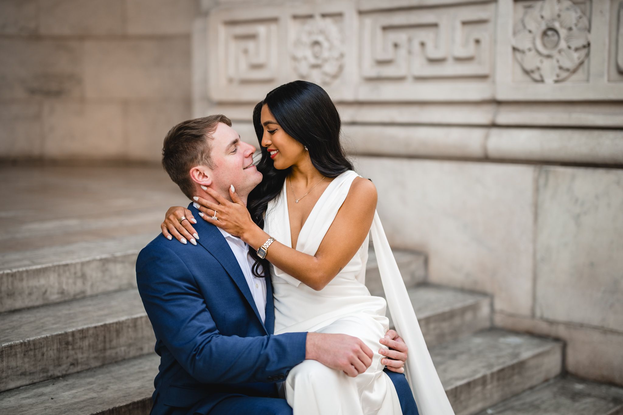 Intimate moment captured on marble steps of historic building.
