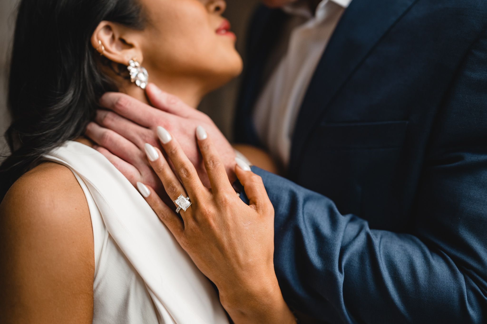 Close-up shots capture intimate moments between couple during engagement session.