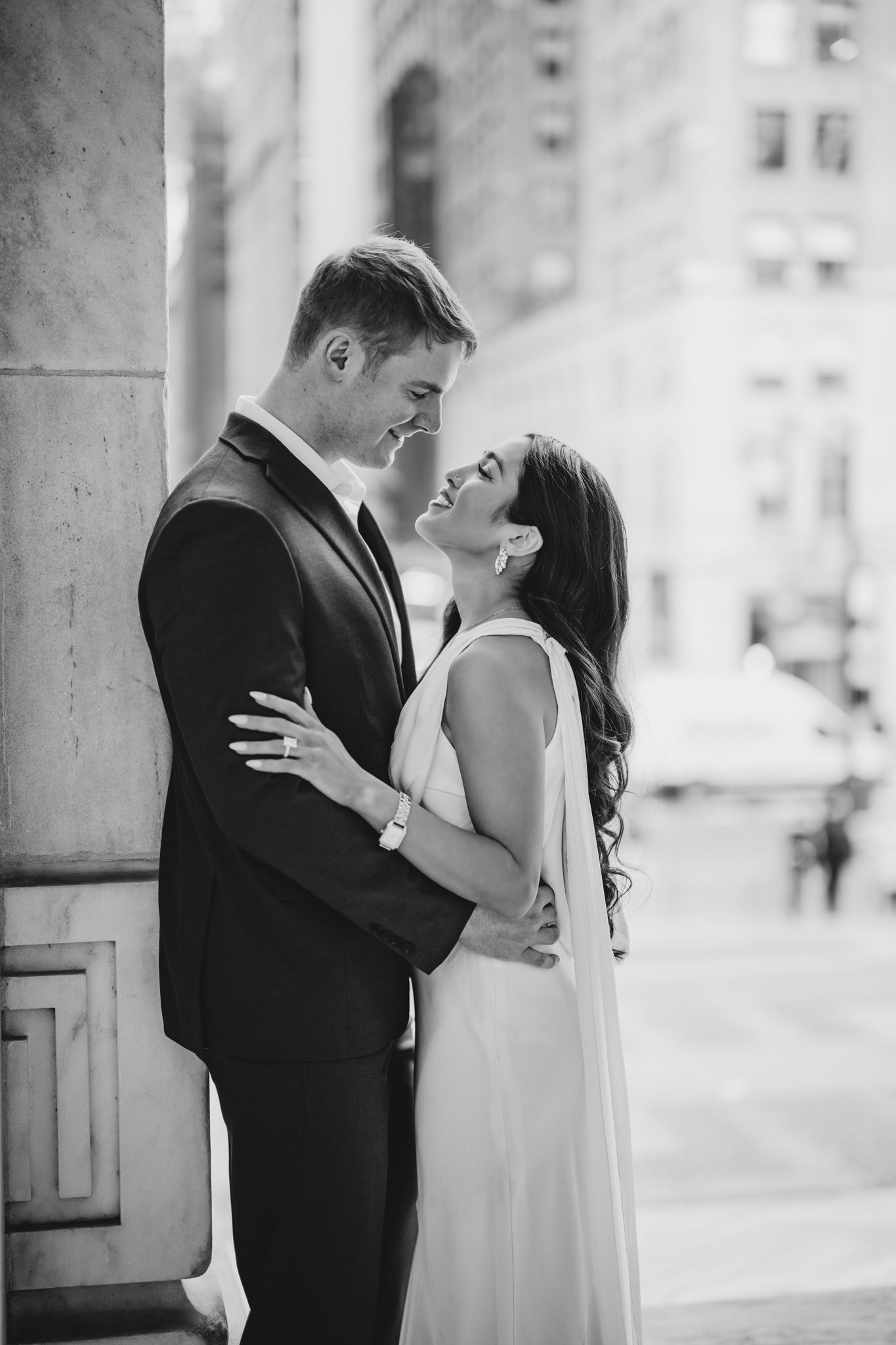 Black and white romantic moment captured in classic architectural setting.