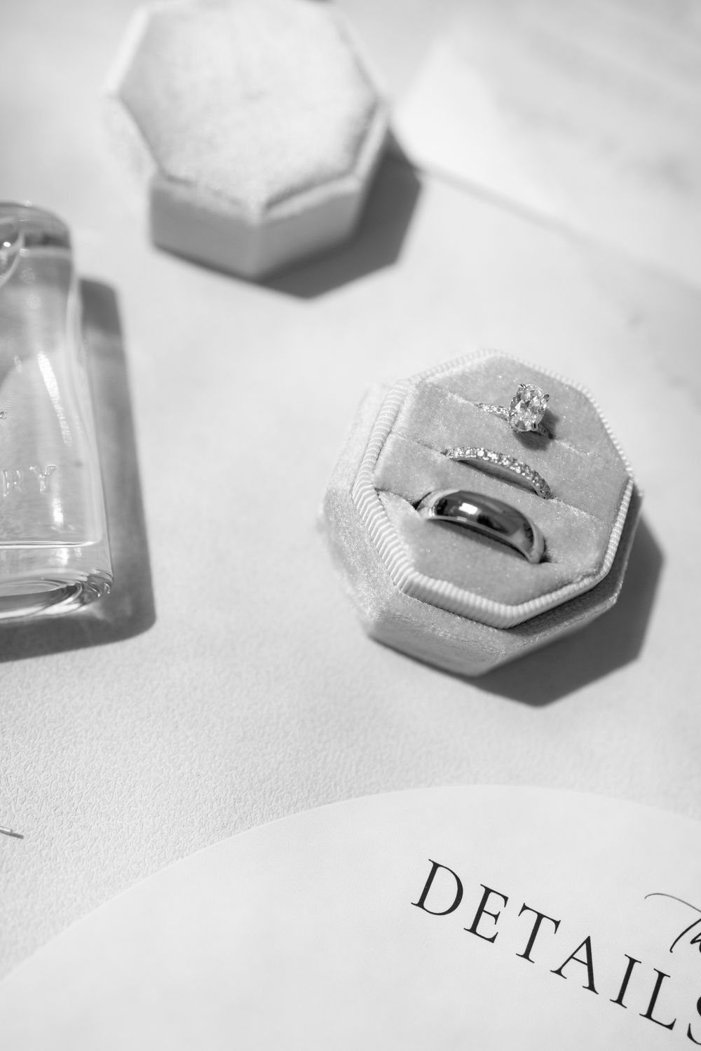 Close-up view of hexagonal silver rings and jewelry pieces arranged on a white surface with text details below.