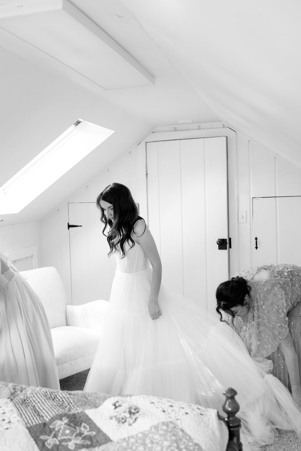 A sequence of black and white photos showing a bride in a flowing white dress moving gracefully in a bright attic space.