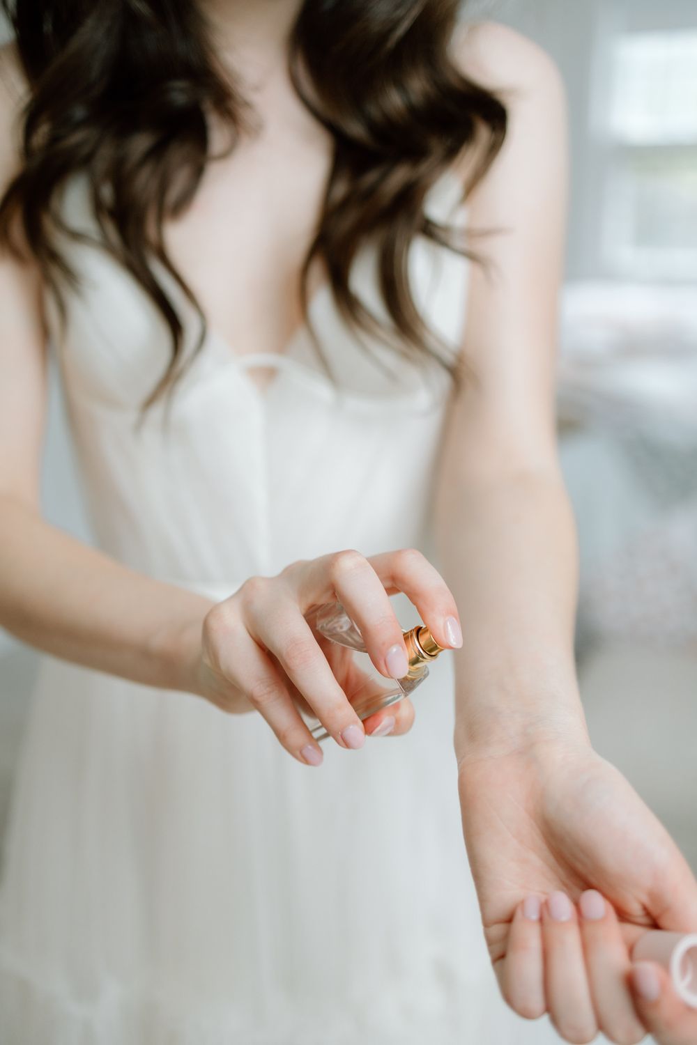 Close-up series of hands showing delicate gold rings with floral and nature-inspired designs on pale skin.