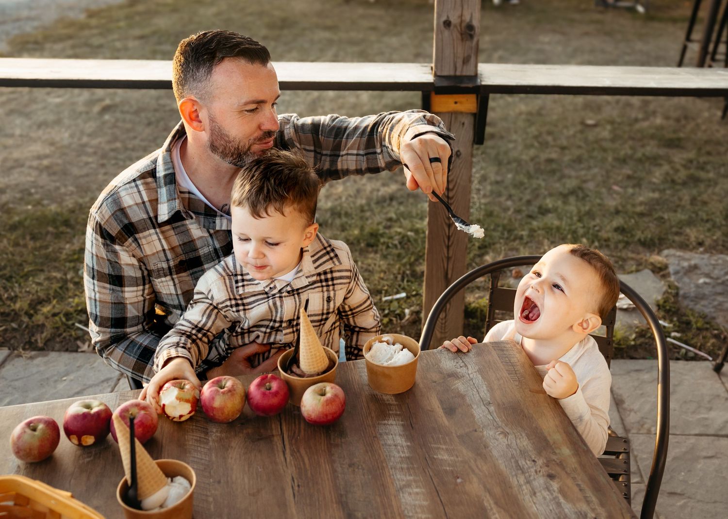 A sequence of candid moments showing a caramel apple being enjoyed at a rustic wooden table.