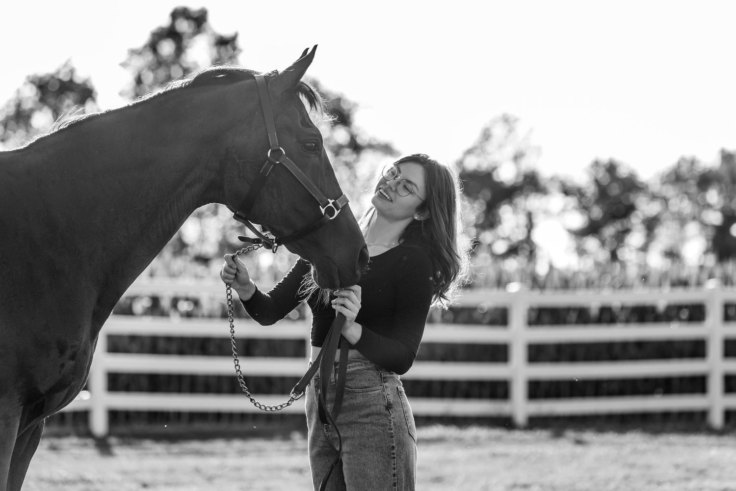 Black and white photo of a horse and rider during an equestrian session.