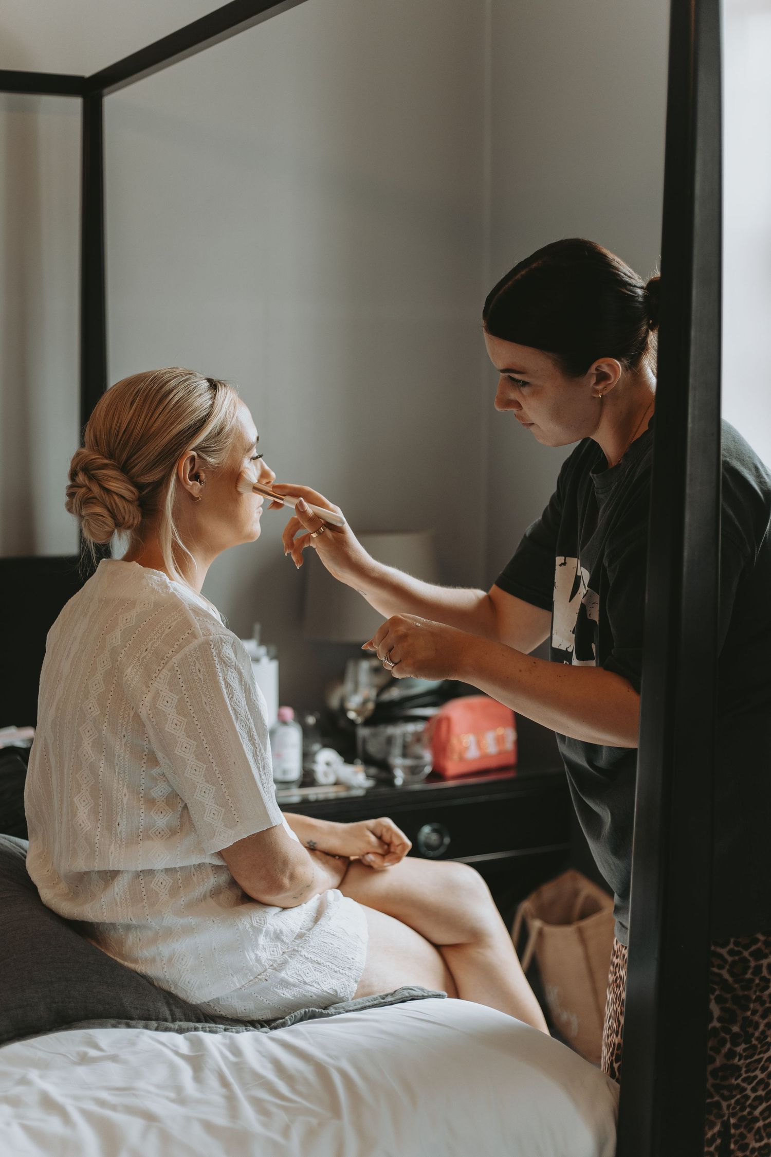Wedding day makeup application in progress in a bright, modern room.