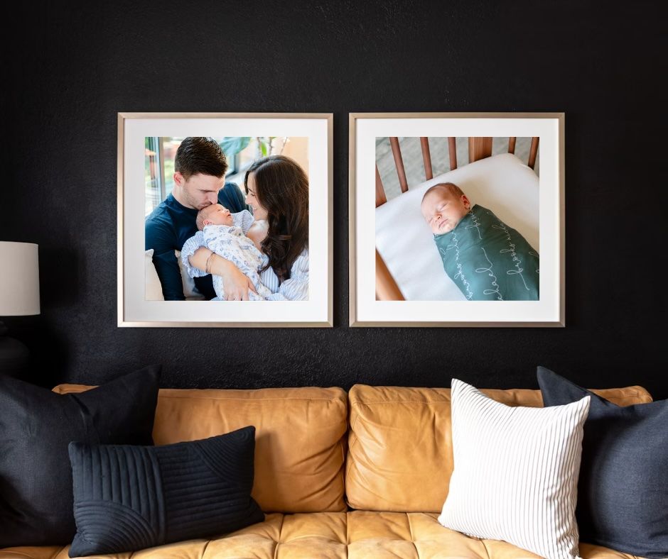 Two large framed photos displayed above a brown leather couch with decorative pillows.