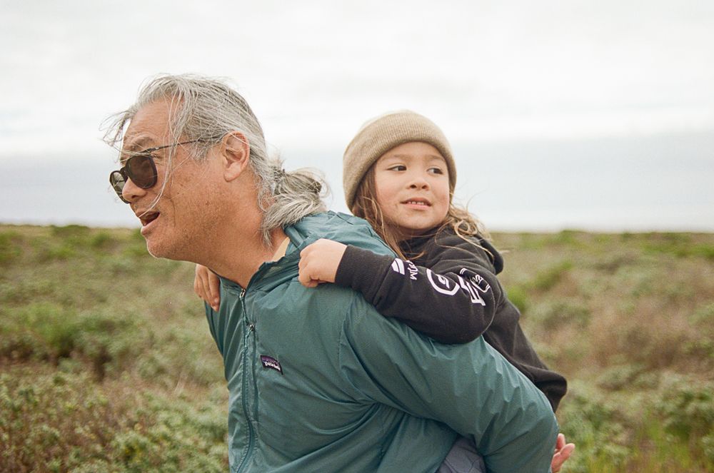 Outdoor adventure scene with two companions enjoying a playful moment in a natural setting.