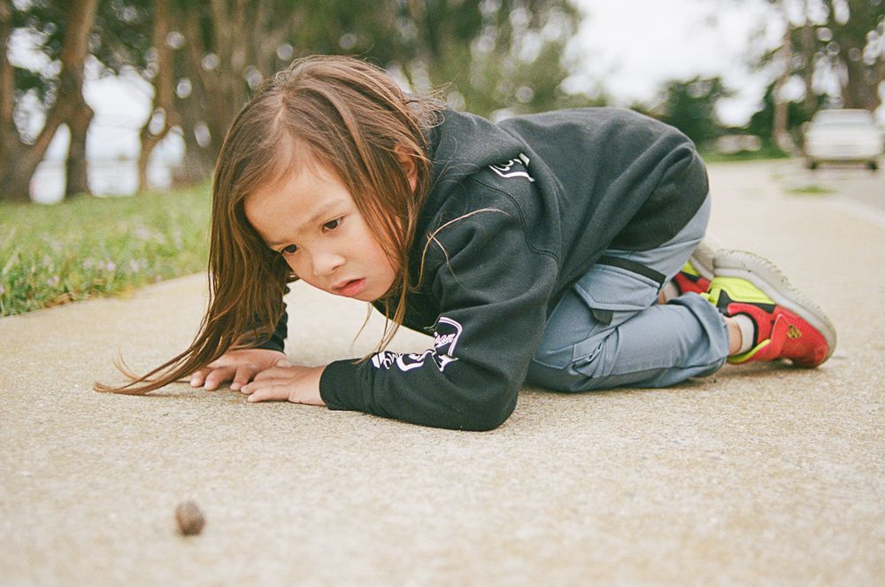 A sequence showing someone lying down while playing with a small object.