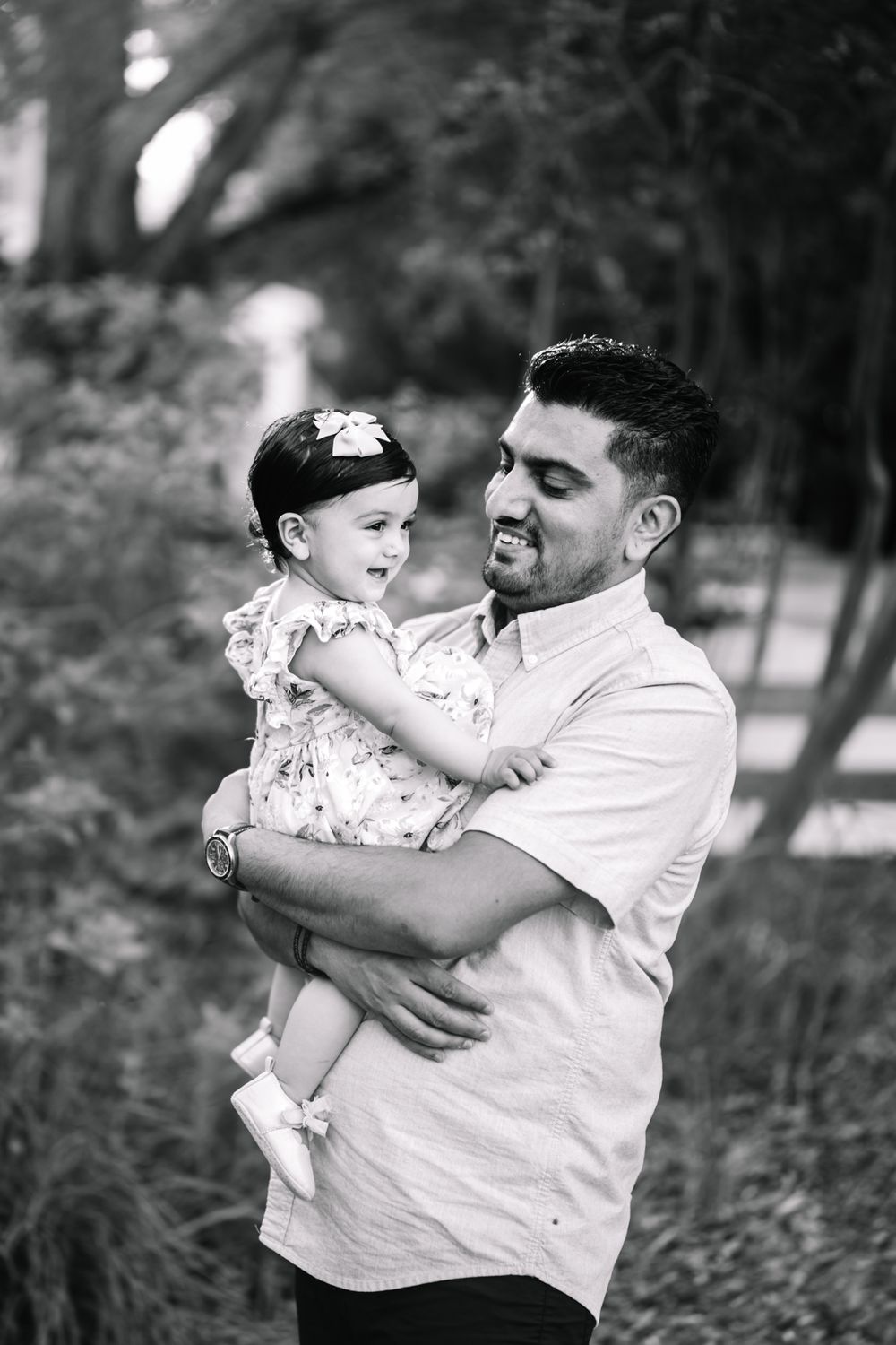 A  dad with his 11 month old daughter holding her