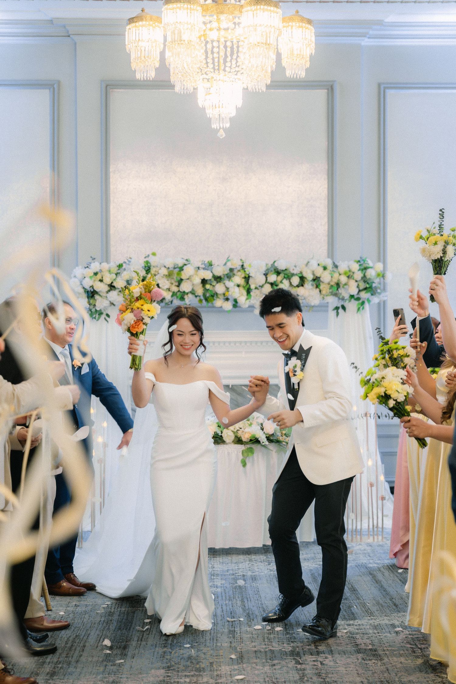 bride and groom walking down the aisle together during an indoor wedding ceremony
