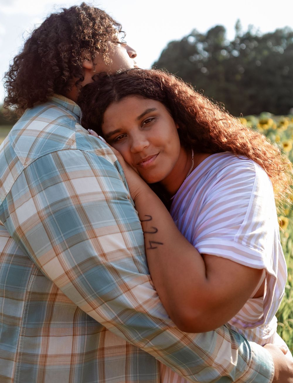 Authentic couple's lifestyle photography in a sun-drenched field in Lincoln, Alabama.