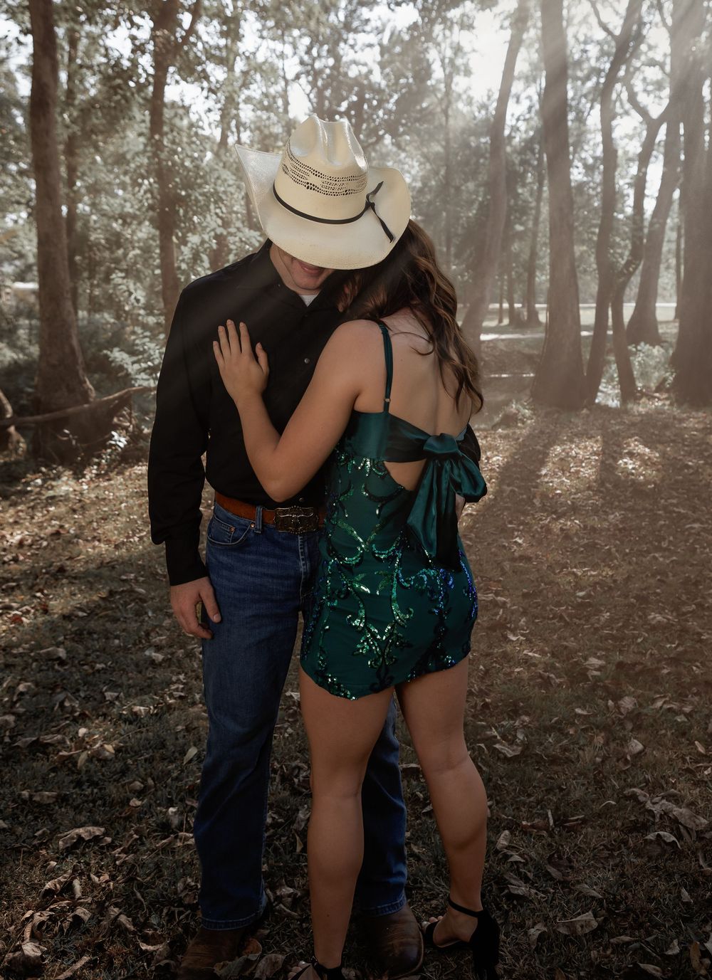 Candid couple's session in the woods of Lincoln, Alabama featuring western-inspired style and natural light.