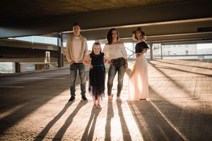 Long shadows cast on concrete floor as group walks together.