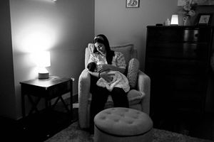 Moody black and white nursery photos showing quiet moments in dim lighting.