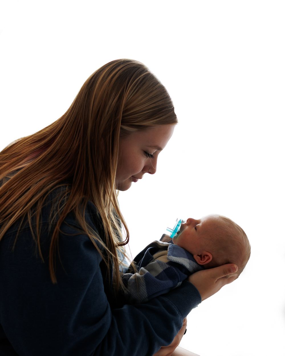 A series of silhouette photos showing a person holding and caring for a baby against a white background.