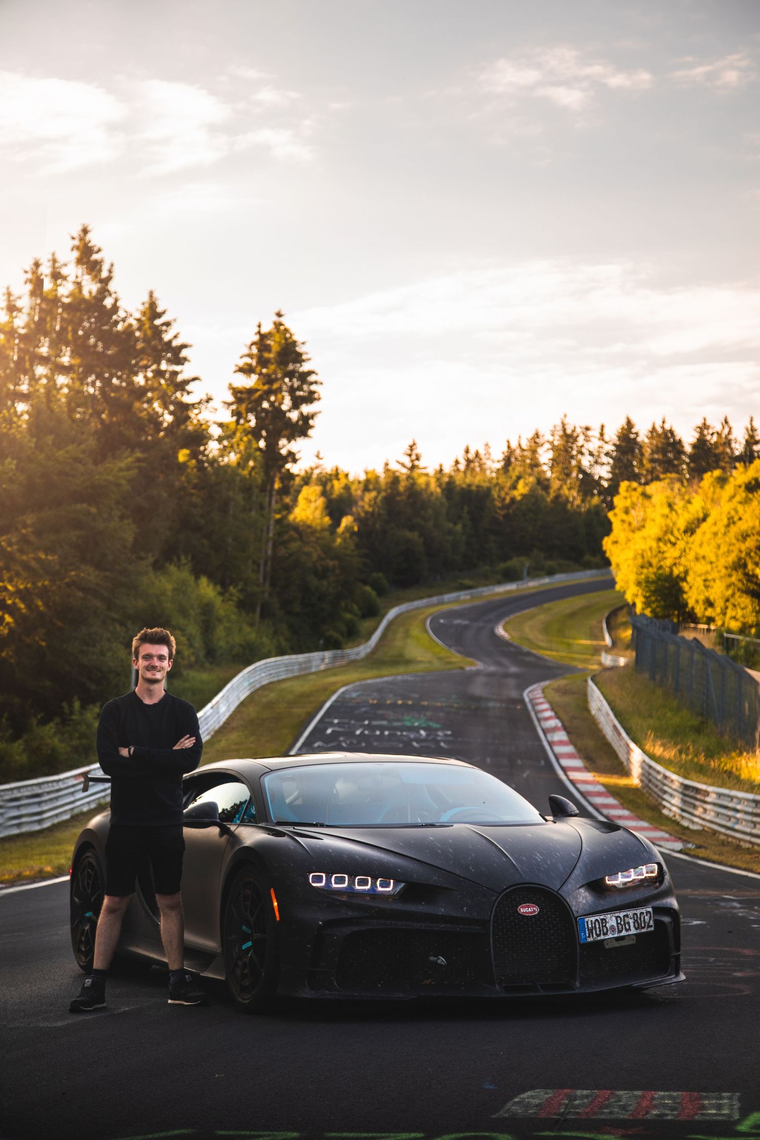 Photo of Tom Stamp stood next to a Bugatti Chiron on the Nürburgring after a photo shoot.