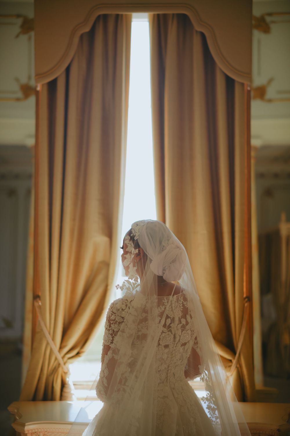 A series of dreamy photographs showing a backlit window with flowing golden curtains and a veiled figure in white.