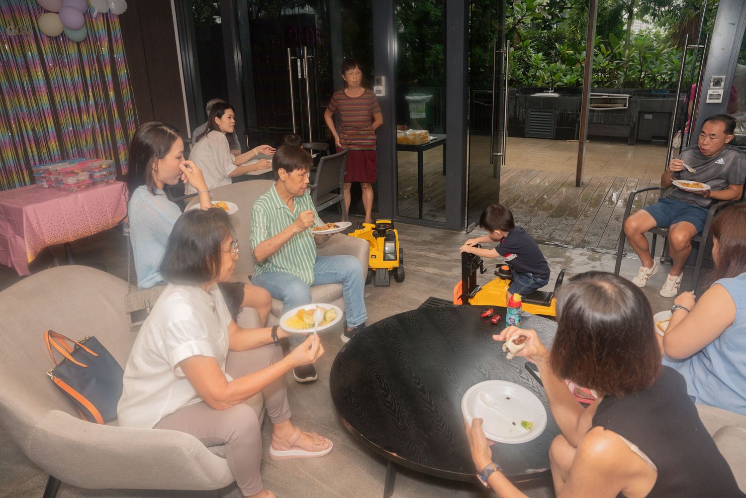 A group of people gathered around a table playing board games in a casual indoor setting.