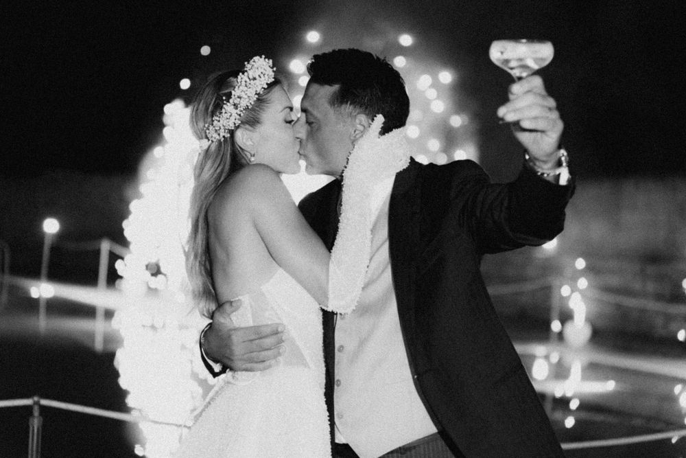 A black and white wedding photo montage shows romantic moments between a couple dancing and kissing at night.