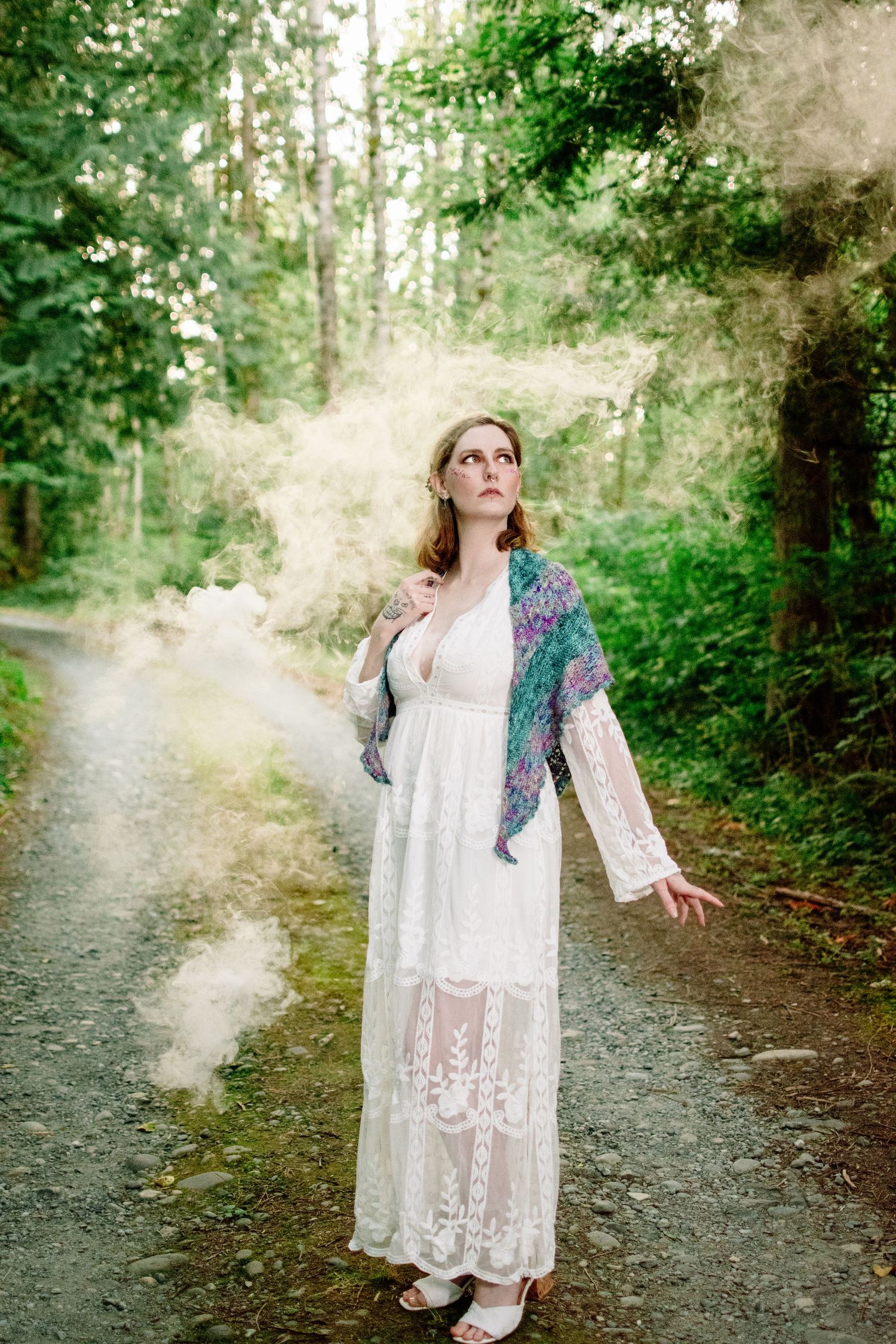 Fine art styled portrait with lace gown and atmospheric smoke at The Pole Garden Monroe WA.