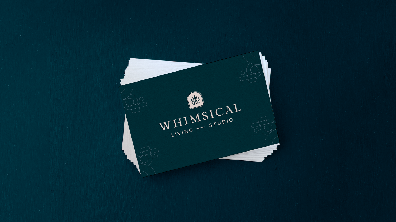 Business cards scattered on dark background showing minimalist branding design.