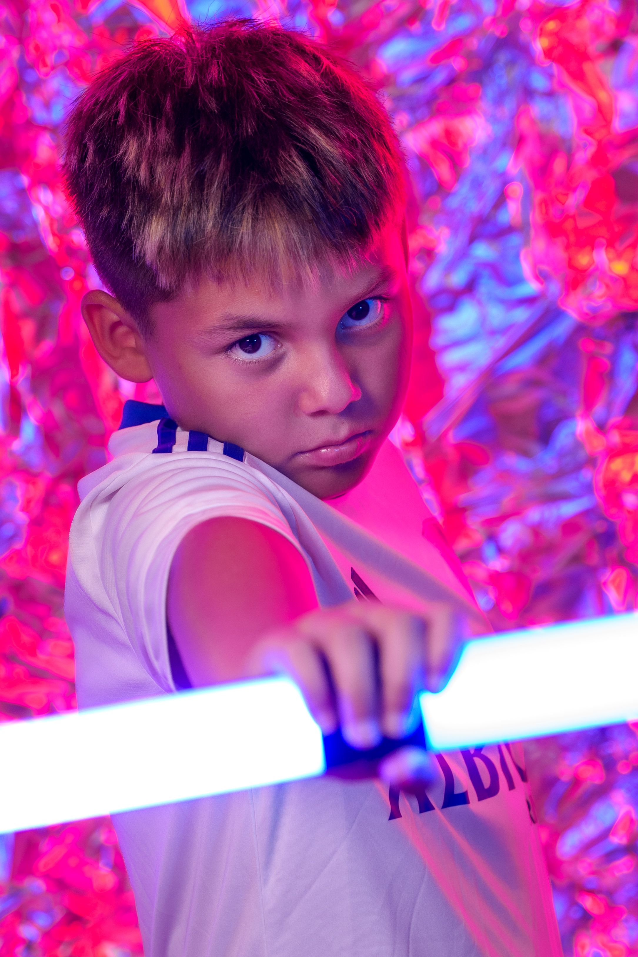 Dynamic poses with light effects showing martial arts inspired movements in white jersey.