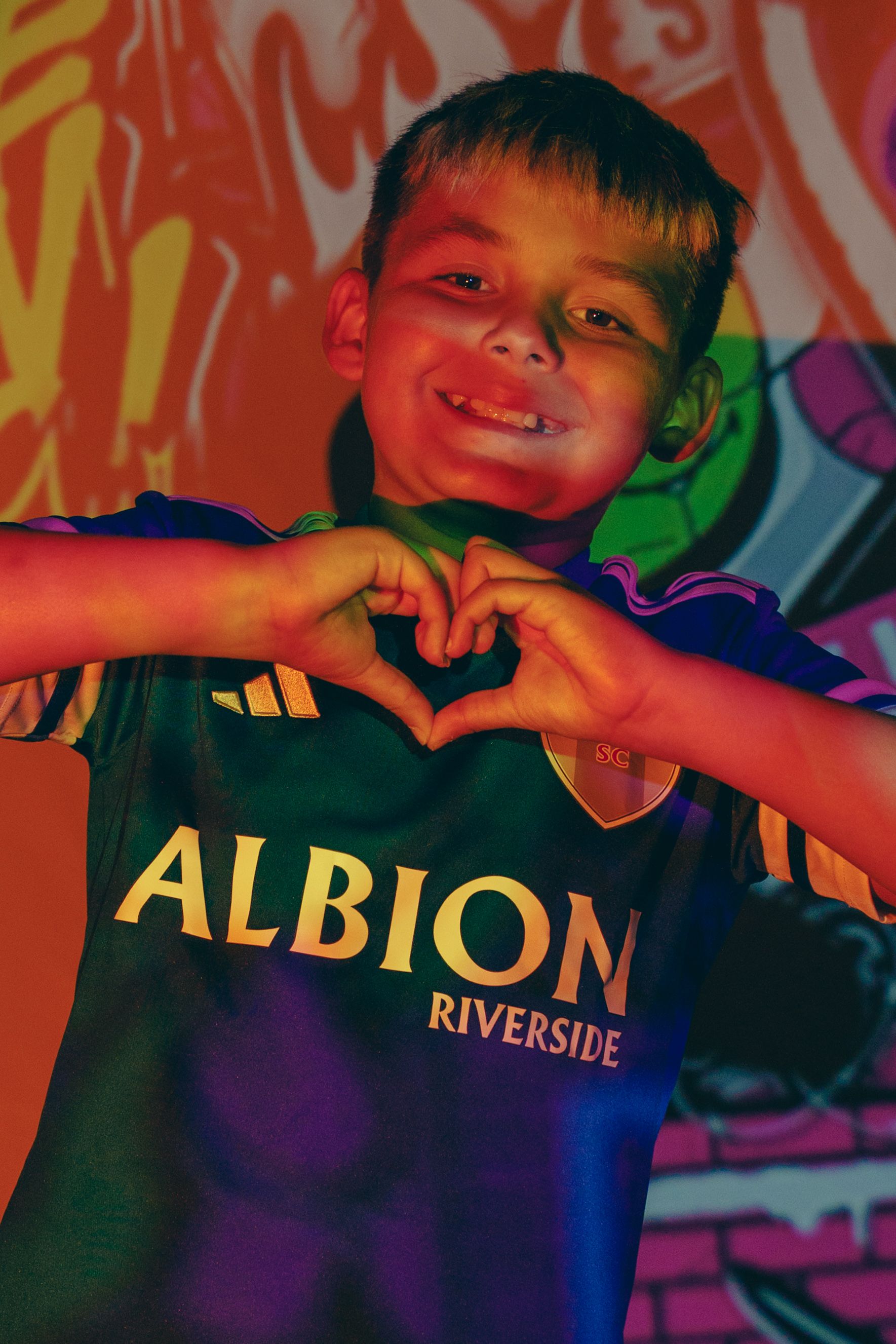 Sports jersey photography with colorful lighting and Albion Riverside text visible.