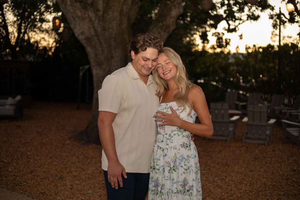 Romantic sunset photoshoot in a wooded area with warm evening lighting.