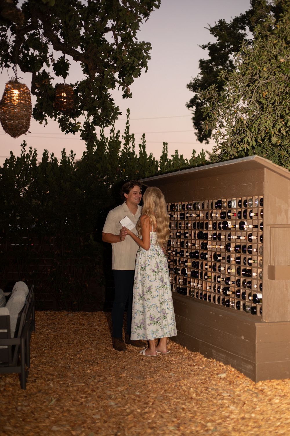 A romantic evening scene at a wall of mailboxes surrounded by autumn leaves and dim lighting.