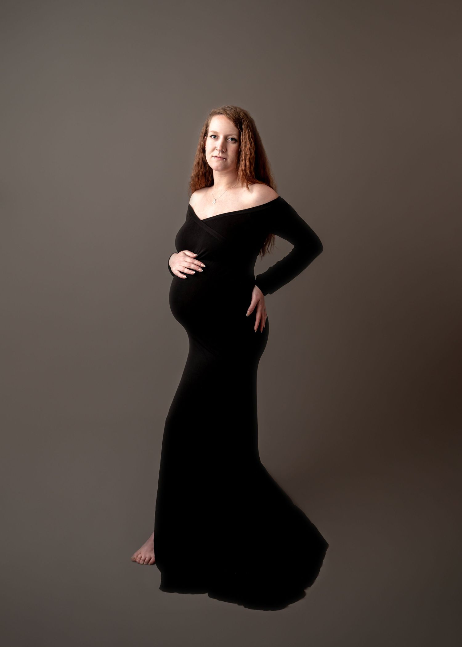 A sequence of five images showing a person in a black dress spinning and twirling against a gray background.