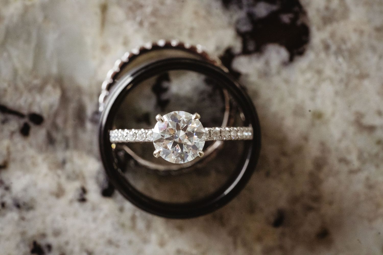 Wedding ring set showcased in a creative photo sequence showing different angles on a dark textured surface.