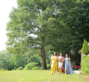 Candid photo of bride procession with their bridesmaids during wedding photo session.