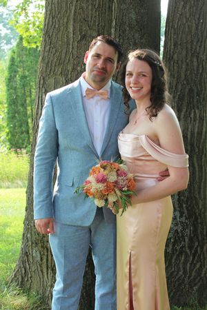 Married couple poses during wedding photo session.