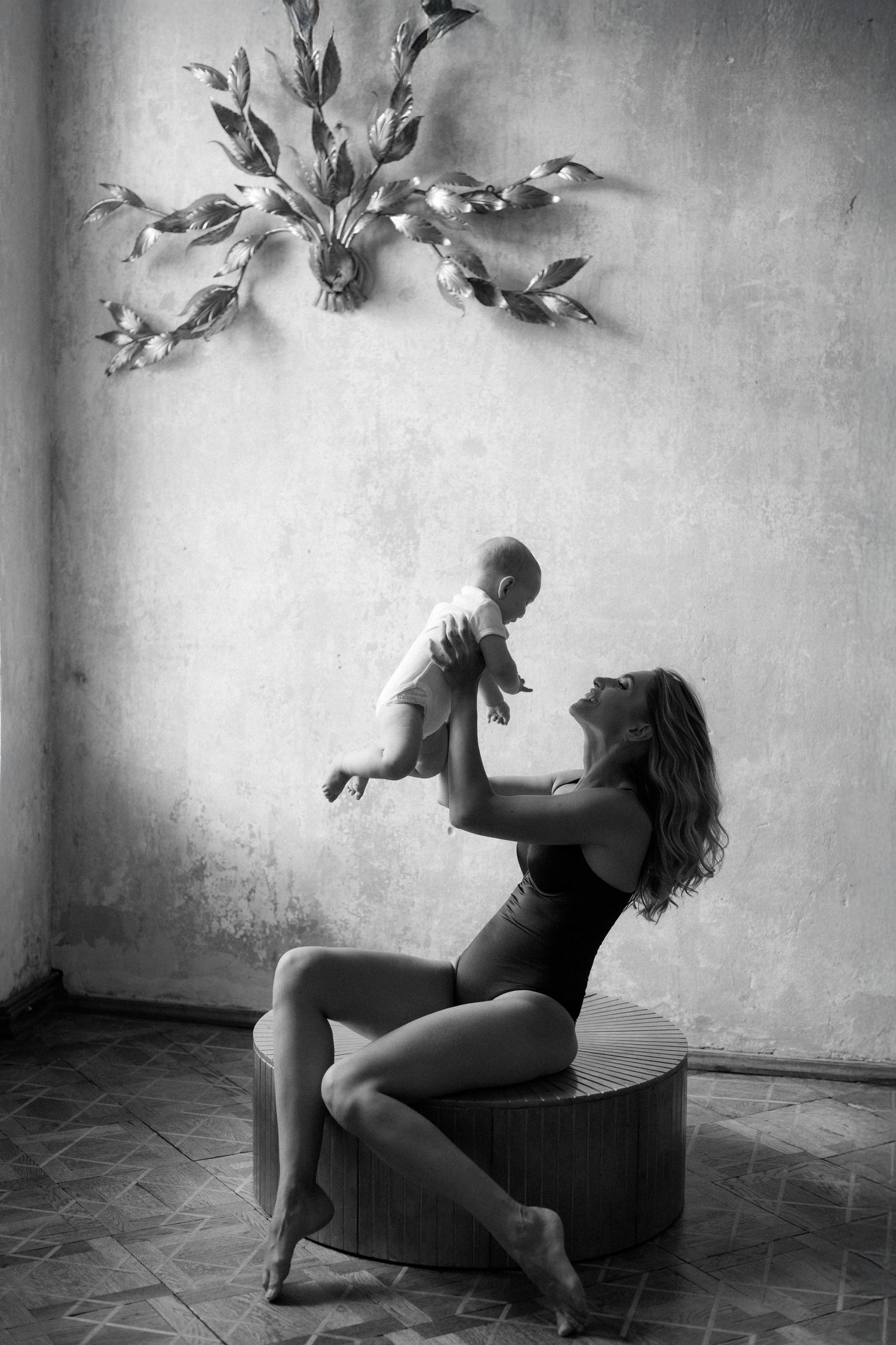 A series of black and white artistic photographs showing a dancer performing expressive movements in a minimalist setting.