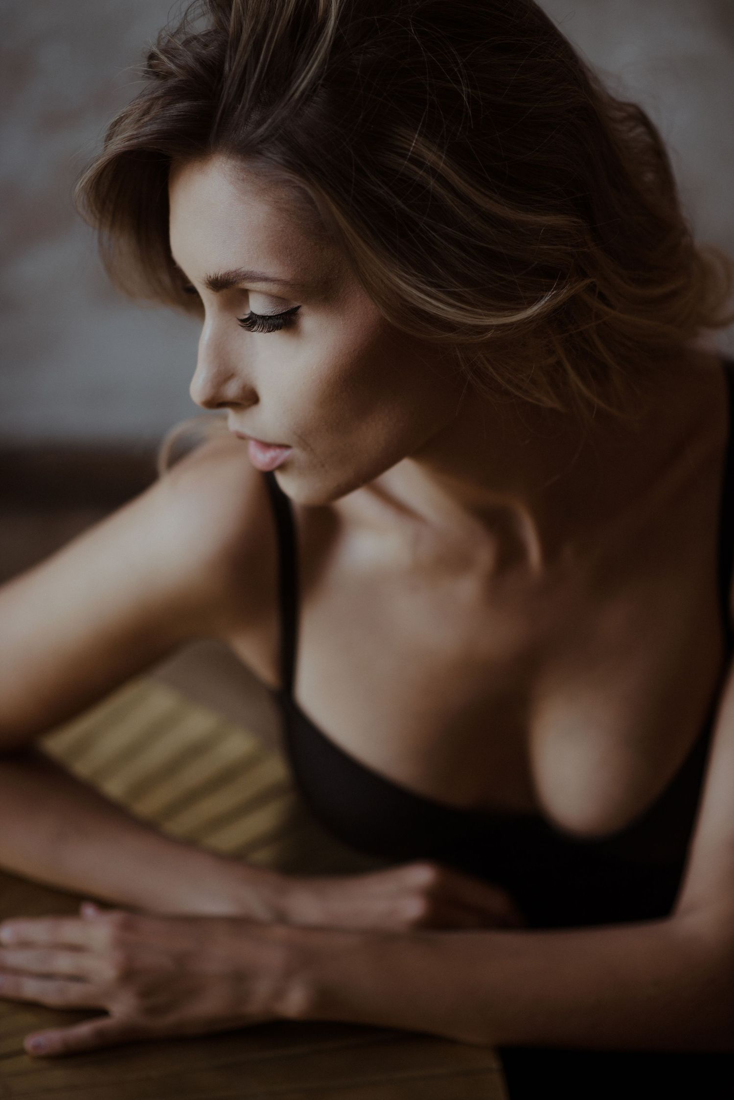Intimate black and white portrait series capturing soft poses and delicate shadows in moody lighting.