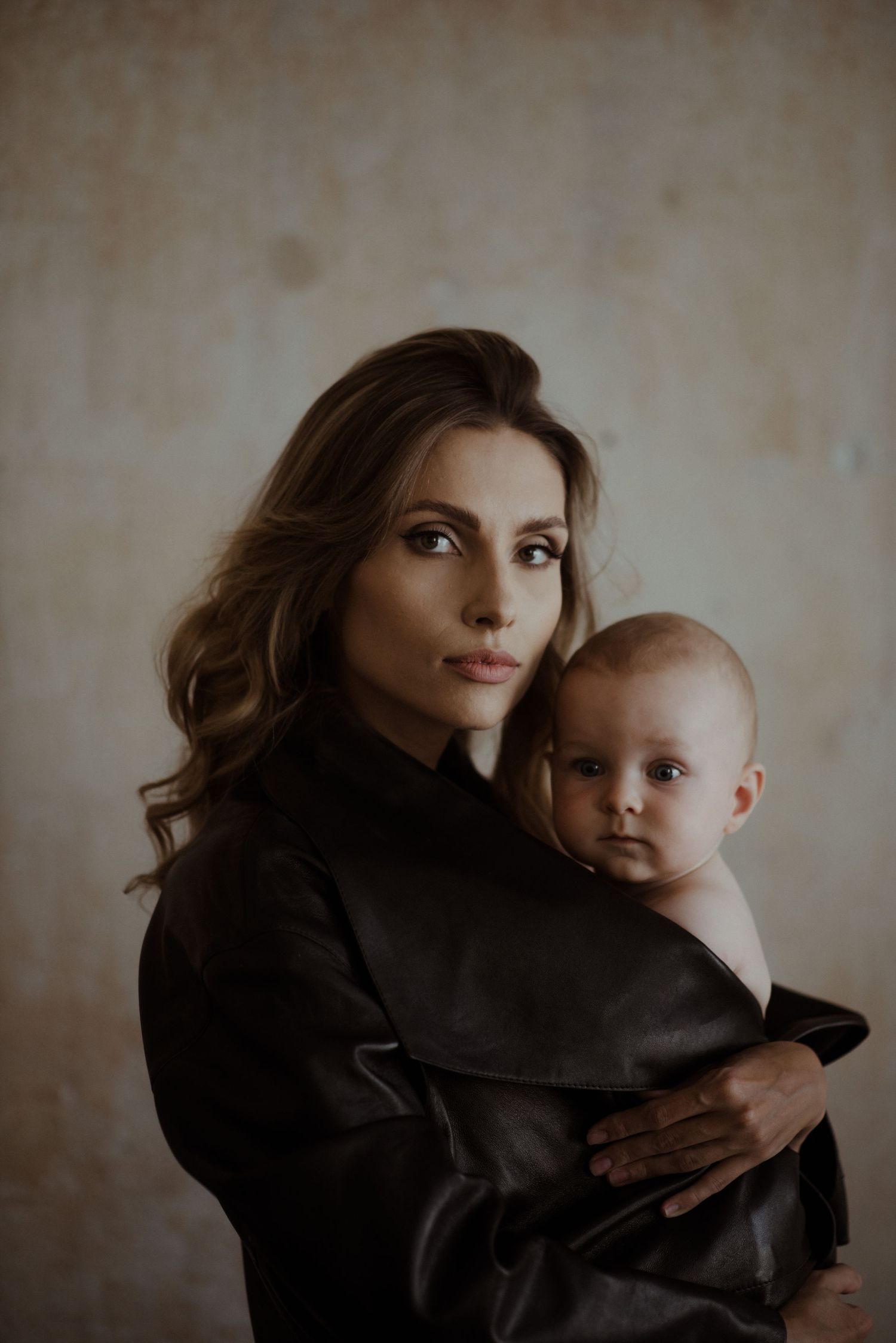 A collection of intimate photographs showing tender moments between a caregiver and infant in muted tones.