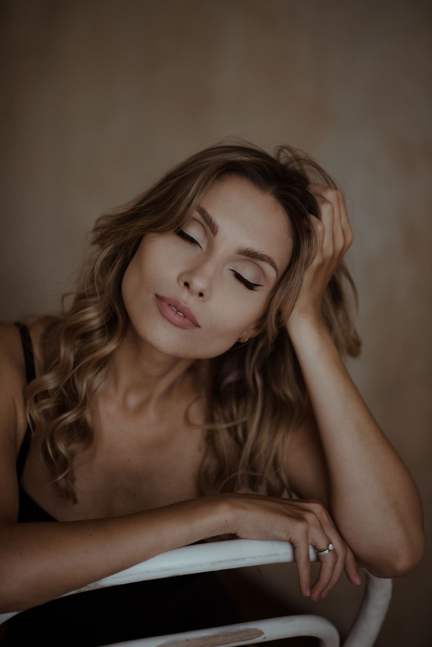 Artistic portrait series showing woman in soft lighting with tousled brown hair resting in serene poses.