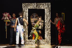 A dramatic theater performance sequence showing actors in ornate silver picture frames against a dark background.