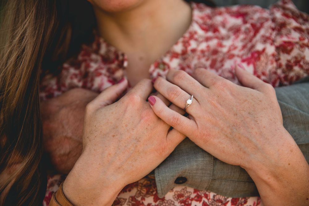 Close-up shots of a romantic embrace between a couple wearing casual attire outdoors.