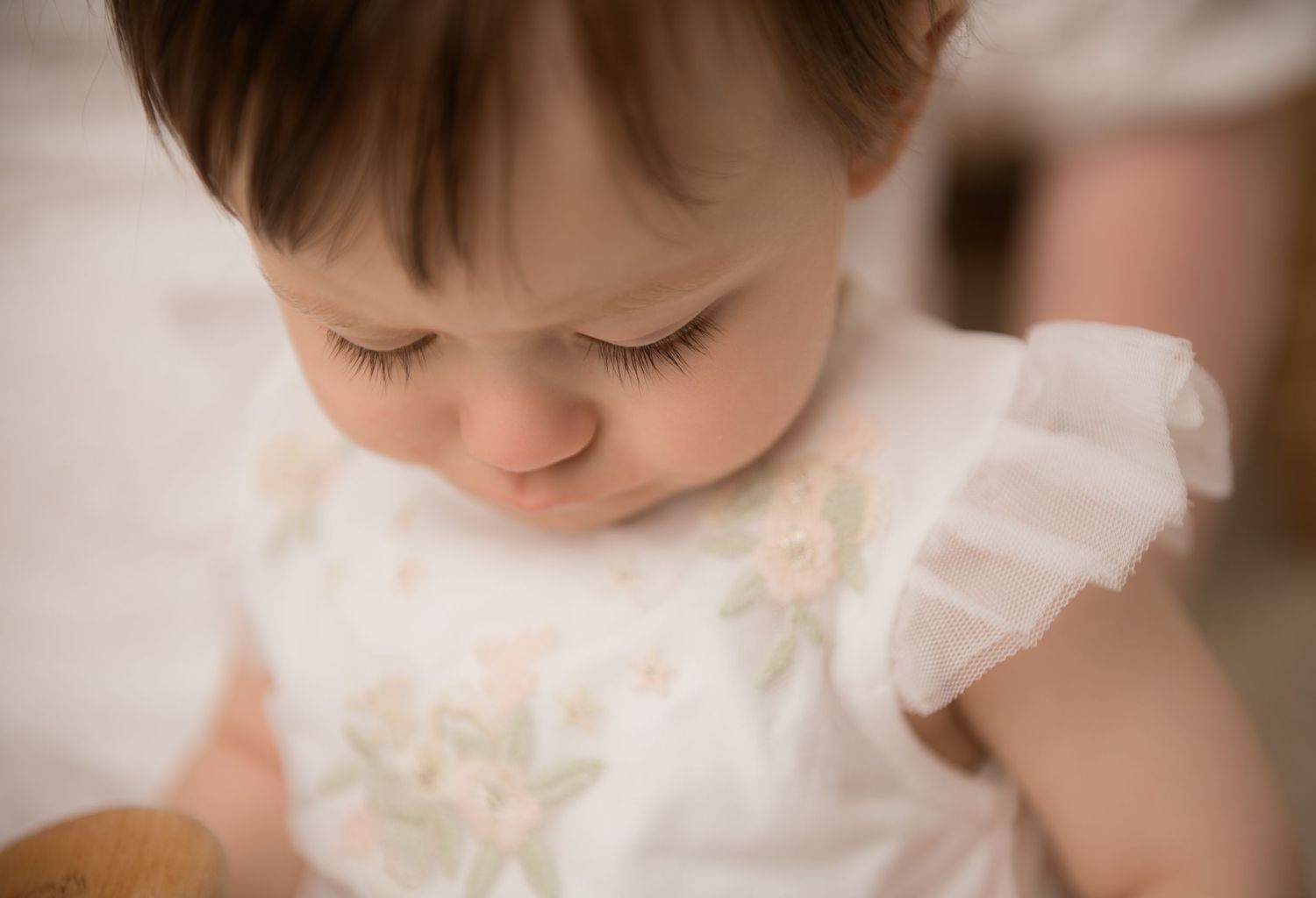 Close-up macro photo of a young child's facial features at her sitter milestone photography session.