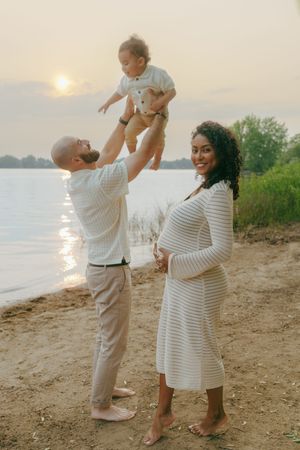 Beautiful beach sunset photoshoot showing joyful family moments along the waterfront.